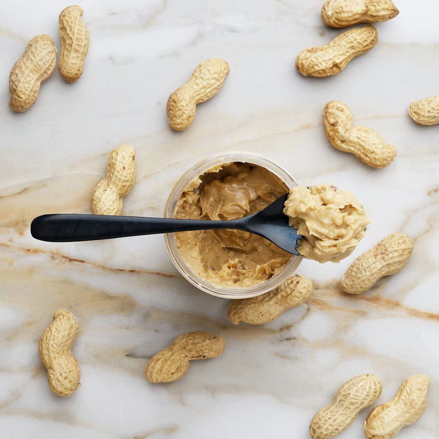 Spoonful of peanut butter with peanuts