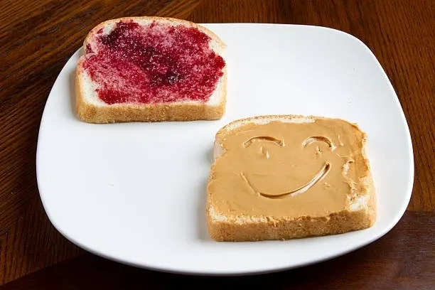 Smiling peanut butter toast and jelly slice